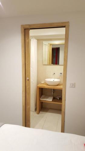 a bathroom with a sink and a mirror at Hotel Du Clocher in Chamonix-Mont-Blanc