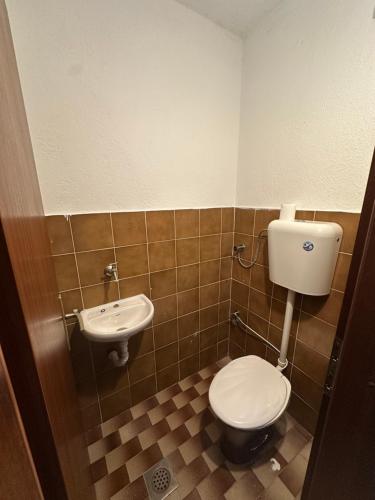 a bathroom with a toilet and a sink at Lea Apartment in Struga