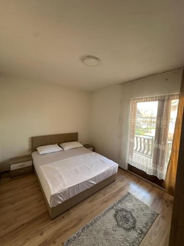a bedroom with a large bed and a window at Lea Apartment in Struga
