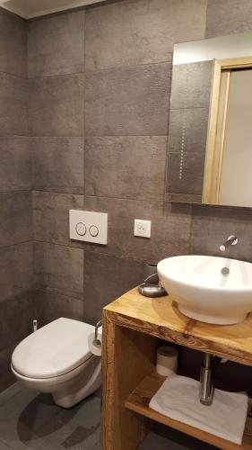 a bathroom with a sink and a toilet at Hotel Du Clocher in Chamonix-Mont-Blanc