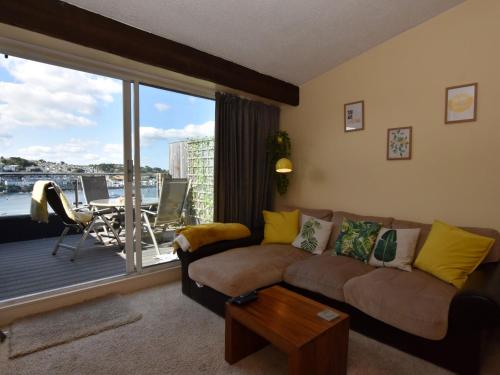 a living room with a couch and a balcony at 2 Bed in Polruan 75740 in Polruan