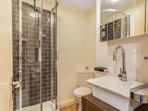 a bathroom with a toilet and a sink and a shower at 2 Bed in Polruan 75740 in Polruan