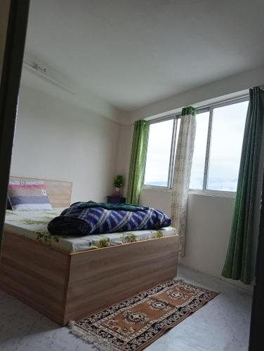 a bedroom with a bed and a large window at Winter Inn Homestay in Lava