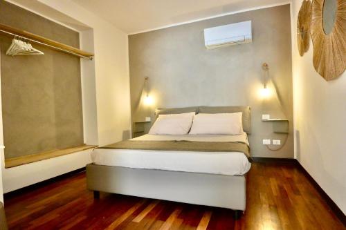 a bedroom with a large bed with a window at Cala Prodani Rooms in Savona