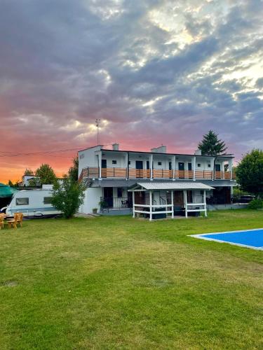 a building with a pool in front of a yard at Oaza Pieczyska in Koronowo
