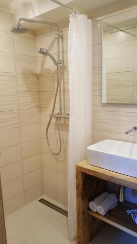 a bathroom with a sink and a shower at Hotel Du Clocher in Chamonix-Mont-Blanc
