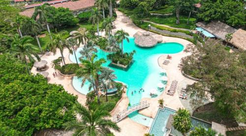 an aerial view of a pool at a resort at Matapalo Diria #504 Amazing Condo-Ocean View in Tamarindo