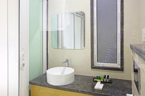 a bathroom with a sink and a mirror at AIRPORT HOTEL ELEVATE NEAR Delhi Airport WITH- Free Airport PICKUP in New Delhi
