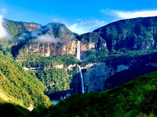 a waterfall in the middle of a mountain at La Casa de Mario - Gocta in Cocachimba