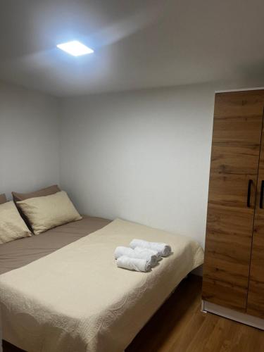a bedroom with a bed and a dresser with towels on it at Dorotea Apartment in Ohrid