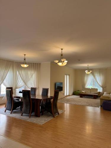 a living room with a table and chairs and a couch at Family cottage in Bosteri