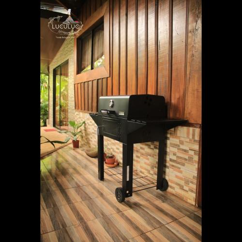 a black piano sitting in front of a house at Cabaa Luculuc Garden Forest in San Pedro