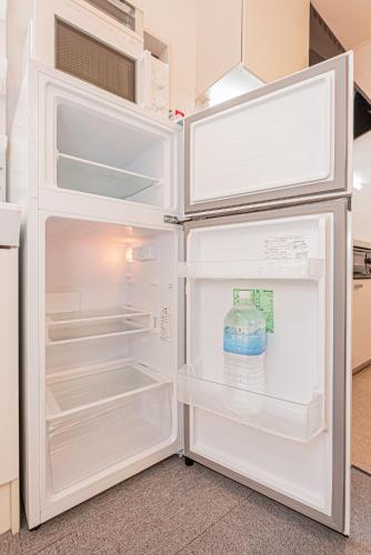 an open refrigerator with a bottle of water in it at 8 min walk to JR Chuo Sobu Line Station Ground Floor Room 13 min to Tokyo Direct Train to Asakusa Shinjuku Ueno Akihabara 22sqm in Tokyo