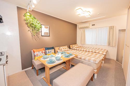 a small living room with a table and chairs at 8 min walk to JR Chuo Sobu Line Station Ground Floor Room 13 min to Tokyo Direct Train to Asakusa Shinjuku Ueno Akihabara 22sqm in Tokyo