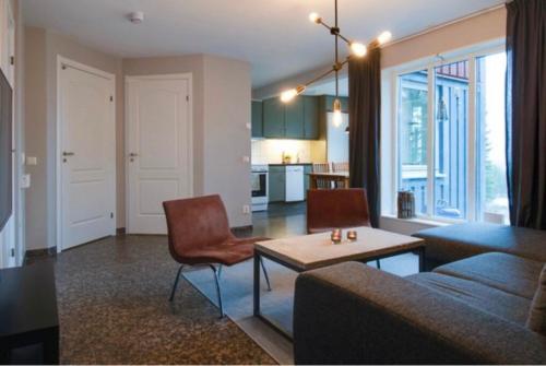 a living room with a couch and a table at Lägenhet i Klövsjö in Herräng