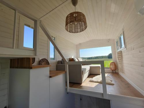 a tiny house with a bed in a room at Under Canvas Bornholm in Østermarie