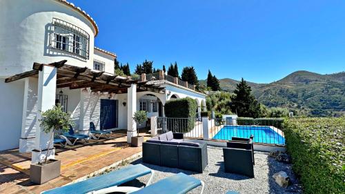 a villa with a swimming pool and a house at Villa Málaga con Piscina Vallada, Barbacoa y hermosas vistas by AndaraHolidays in Málaga