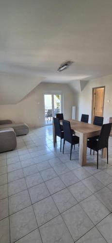 a dining room with a table and chairs at Maycherry Apartments in Siófok