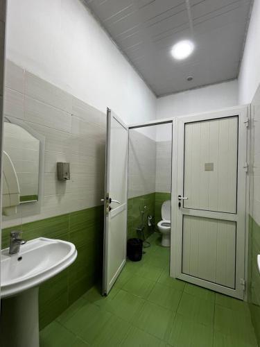 a bathroom with a white sink and a toilet at FRIENDS Hostel Baku in Baku