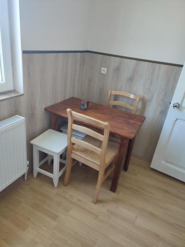 a wooden table and two chairs and a wooden table and chairsuggest at Tuz House R7 in Bakuriani