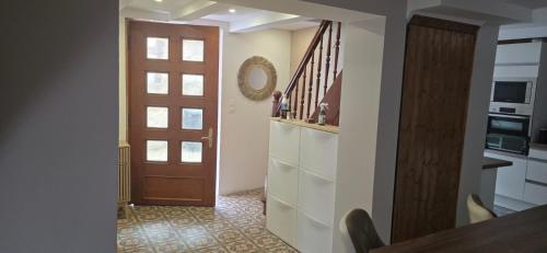 a hallway with a door leading to a kitchen at Maison de village à 15 min de Strasbourg in Duppigheim