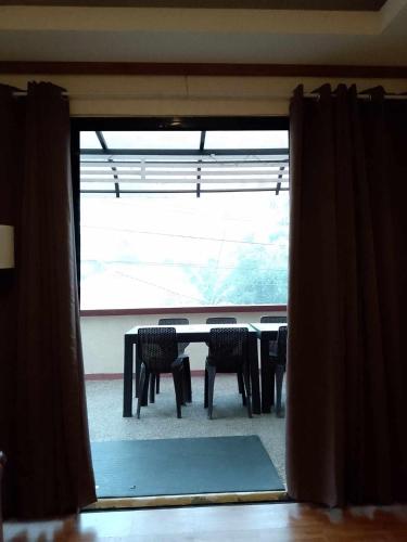 a table and chairs in a room with a window at CasaCavite - Your Chill Hideaway and Mini-Resort Just Minutes from all the Tagaytay-Silang-Nuvali Action! in Silang