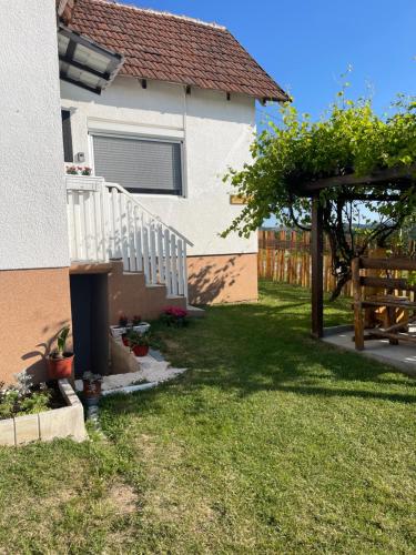 a yard with a white staircase and a house at Dedina kuća in Gornji Milanovac