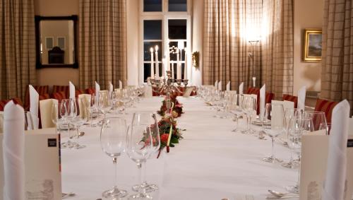 a long table with wine glasses and flowers on it at Schloss Berge in Gelsenkirchen