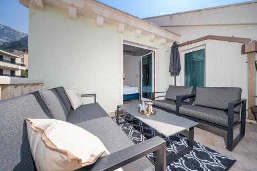 a living room with a couch and a table at Villa Božica - sea view stone villa with free parking in Makarska