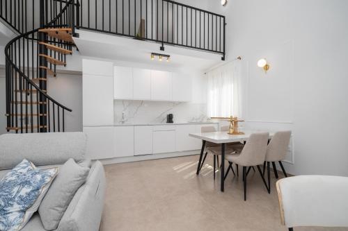 a living room with a couch and a table at Villa Božica - sea view stone villa with free parking in Makarska