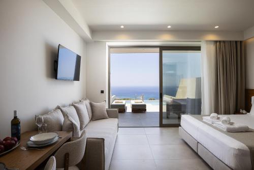 a living room with a couch and a table at Mouria Luxury Suites - Adults Only in Falasarna