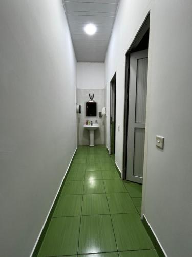 a hallway with a green floor in a room at FRIENDS Hostel Baku in Baku