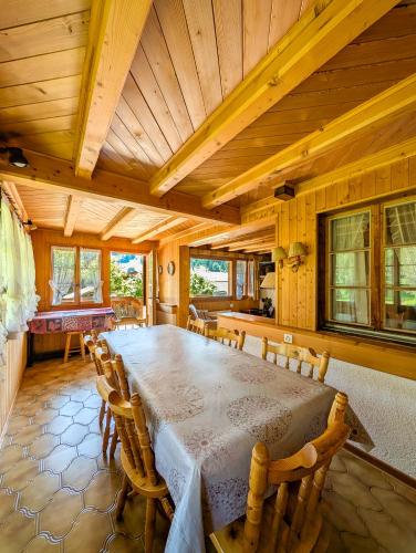 a large wooden dining room with a table and chairs at Havre de paix aux Diablerets - chalet privé in Les Diablerets