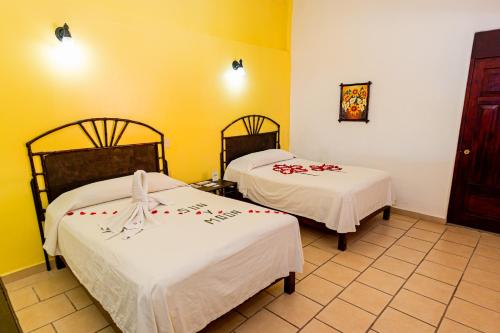 Ένα ή περισσότερα κρεβάτια σε δωμάτιο στο Hotel Casa Sun and Moon