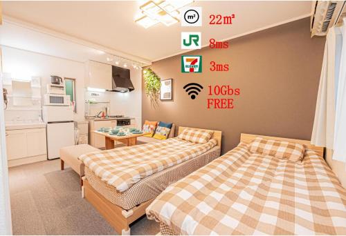 a bedroom with two beds and signs on the wall at 8 min walk to JR Chuo Sobu Line Station Ground Floor Room 13 min to Tokyo Direct Train to Asakusa Shinjuku Ueno Akihabara 22sqm in Tokyo