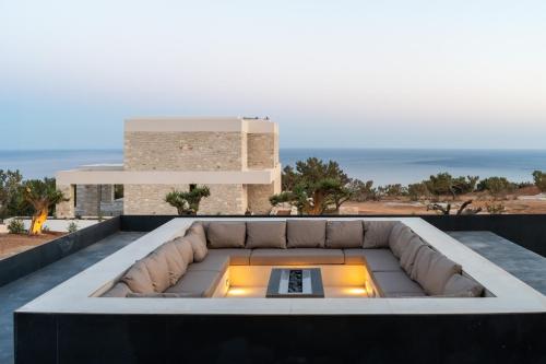 a fire pit on the roof of a house at Seanatra Luxury Villas in Ferma