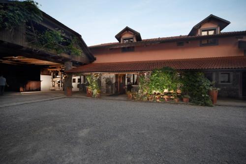 a building with a driveway in front of it at Green Escape garni hotel in Postojna