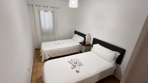 En eller flere senge i et værelse på Anahi Homes Corralejo- Bicacarera 3