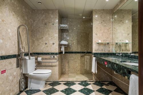 a bathroom with a toilet and a sink at Holiday Inn Porto Gaia by IHG in Vila Nova de Gaia