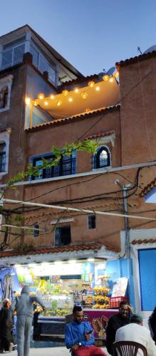 a man standing in front of a fruit stand at Maison de vacances 3 chambres en Medina in Chefchaouene