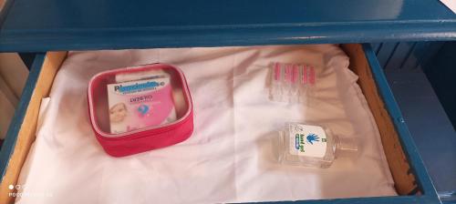 a blue lunch box with a baby kit and other items at Maison Belle Croix in Châtillon-Coligny