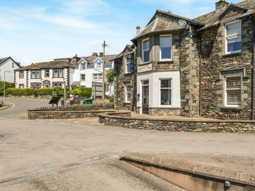 a stone house on a street in a town at 4 Harney Peak in Portinscale