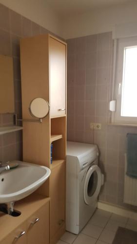 a bathroom with a sink and a washing machine at Wohnung am Hauptmarkt! in Nuremberg