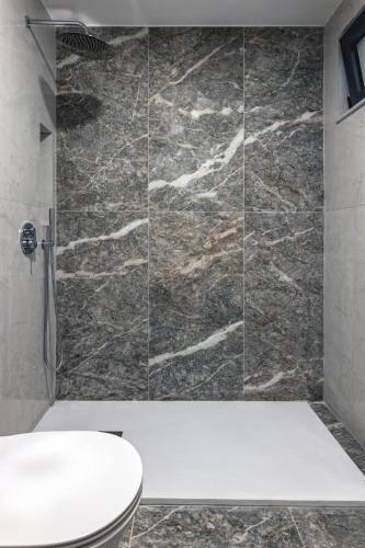a bathroom with a shower with a toilet at Voula Studios in Faliraki
