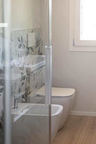 a bathroom with a toilet and a sink and a shower at Ca' Allegra in Mogliano Veneto