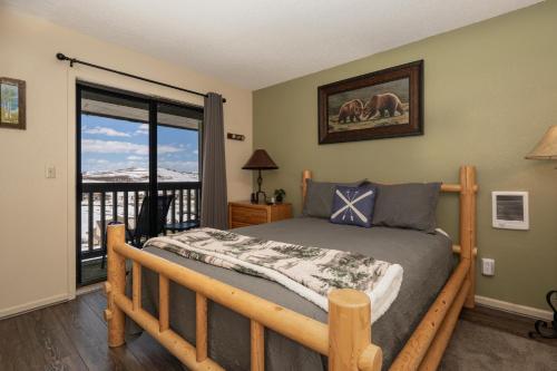 a bedroom with a bed and a balcony at Summit Unit 1303 in Granby