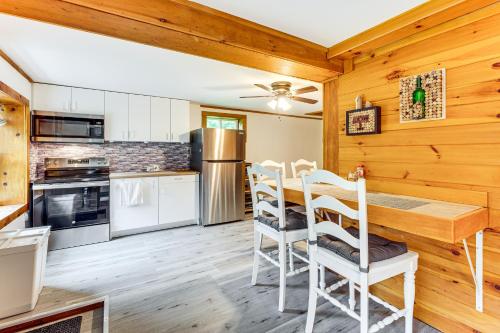 a kitchen and dining room with a table and chairs at 10 Mi to Newfoundland Lake Updated Forest Retreat 