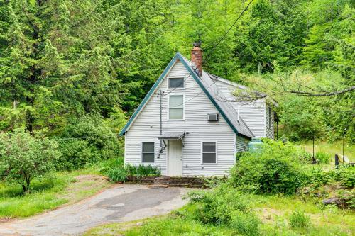 a white house in the middle of a forest at 10 Mi to Newfoundland Lake Updated Forest Retreat 
