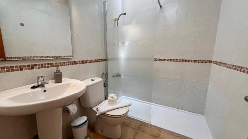 a bathroom with a sink and a toilet and a shower at Anahi Homes Corralejo- Bicacarera 7 in La Oliva