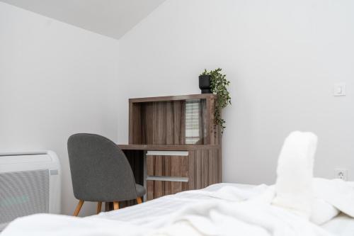 a bedroom with a desk and a chair next to a bed at Villa Božica - sea view stone villa with free parking in Makarska